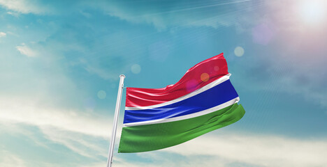 The Gambia national flag waving with beautiful sky.