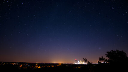 high resolution background image of a night sky with stars in texas with city lights. Generative AI