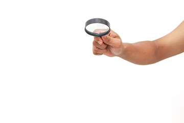 Hand holding a magnifying glass up close on a white background for inspection