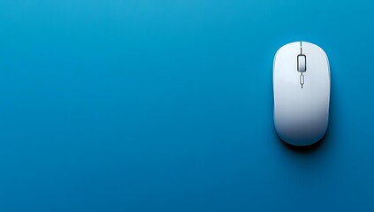 White wireless computer mouse on vibrant blue background with dramatic shadow and copy space for text, minimalist technology concept.