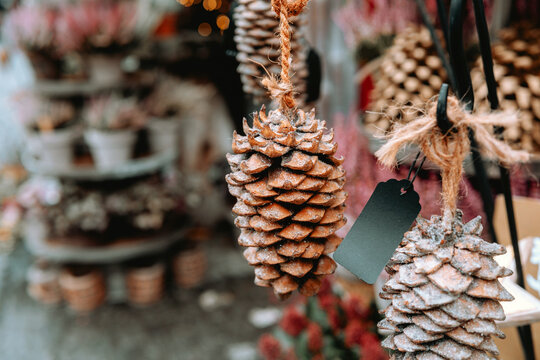 Frosted pinecone ornaments at Christmas market — woody decoration and craft object concept