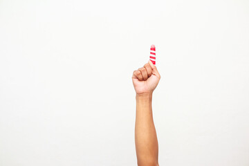 A hand holding a candy cane like object or something with white and red stripes