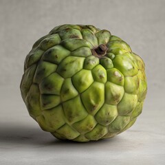 Fototapeta premium Close-Up of Fresh Green Cherimoya Fruit with Textured Skin on Neutral Background