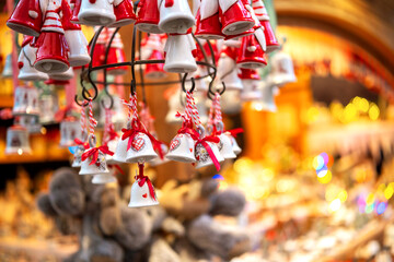 Bright Santa-clad bell ornaments at a Christmas market for childhood nostalgia concept