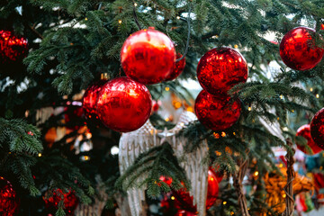 Red Christmas baubles on tree with angel wings for festive tradition concept