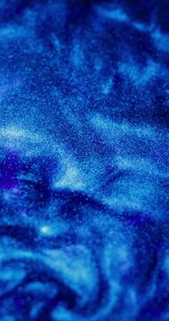 Abstract background. The blue paint with sparkles is bubbling and shimmering