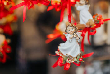 Close-up of porcelain angel with violin and red ribbon for Christmas tree ornament and spiritual...