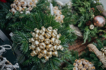 Golden seedpod wreath on pine base for elegant festive nature decor concept