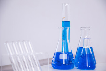 Learning and education for student in classroom under guidance of teacher, experiment uses scientific equipment showing test tube, beaker, droppers, microscope for chemistry analysis, biology research