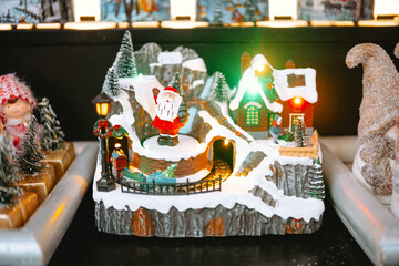 Miniature Christmas village with Santa and train for festive storytelling and holiday decoration...