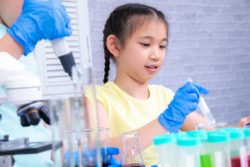 Young students practice in science class in laboratory, two primary children joyful confidence...