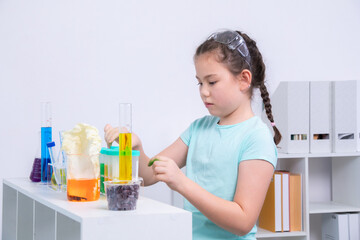 Science education in laboratory experiment session with two children, Asian girl observing...