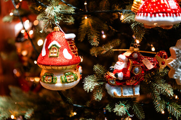Christmas tree with whimsical glass ornaments featuring Santa and cottage for holiday, celebration...