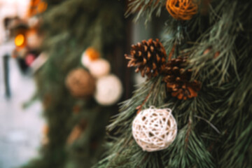 Blurred decorated pine branches with pinecones and natural ornaments for rustic, nature and...