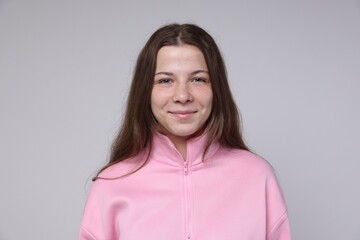 Obraz premium Portrait of teenage girl on light grey background