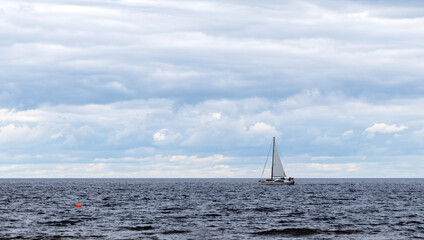 Sailboat on Baltic Sea under Cloudy Sky