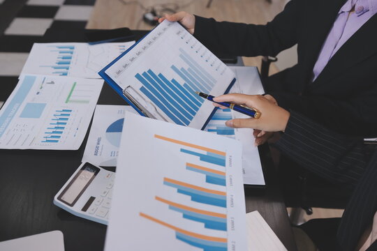 Team of business people working together in the meeting room office,
teamwork background charts and graphs banner, double exposure successful teamwork,business planning concept.