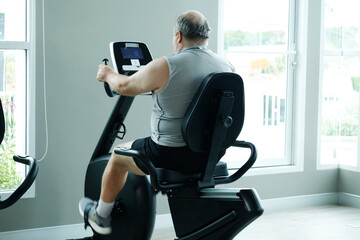 A man using exercise machines at the gym — promoting the concept of exercising for better health.