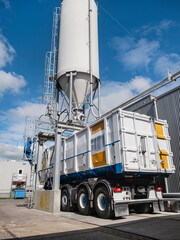 Mobile feed processing truck with tall storage silo for agricultural feed production and distribution operations © Victor