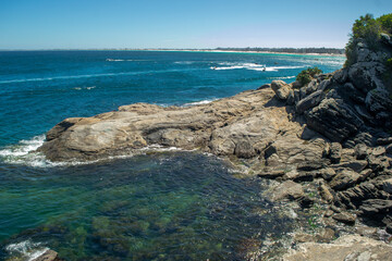Beach at Forte São Mateus with the city of Cabo Frio in the background, lots of undergrowth and...
