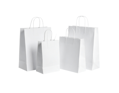 Group of four white paper carrier bags large and small with twisted handles for shopping or gifts.