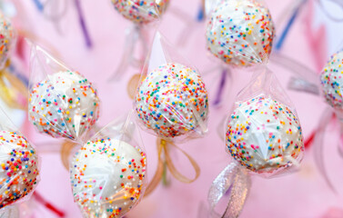 Colorful Candy Delight: Top View of Sweets on Pale Pink Surface