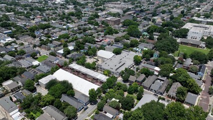 Aerial of residential urban neighborhood homes located in downtown New Orleans, Louisiana with streets and trees during summer heat wave