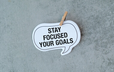 A white sign that says Stay focused on your Goals
