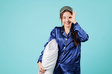 Happy young Asian woman in pajama, pillow, gesturing ok sign, satisfied showing quality after great...