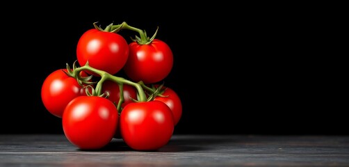 Vibrant red tomatoes against a stark black backdrop, dark food photography, red tomatoes