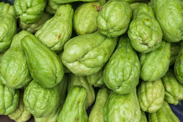A pile of vibrant green chayote, this versatile vegetable is rich in nutrients and flavor, ideal...