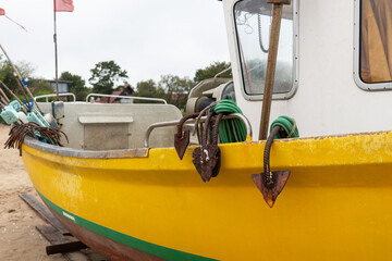 Yellow and White Fishing Boat on a Sandy Shore
