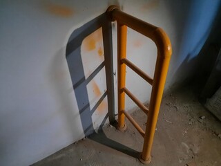 Image of a yellow industrial barrier gate in dim lighting, suitable for themes about construction...