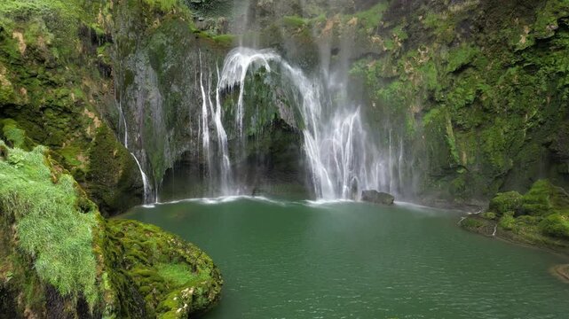 Italy, Umbria, Spectacular drone view of the Marmore Falls with water falling from above in a natural setting of unique beauty with pools of green water immersed in the lush nature