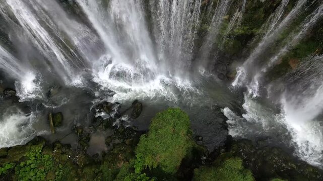 The spectacular waterfall at Marmore Falls, seen from a drone: the melted water from the glacier begins its journey toward the sea after the spring thaw.  drought aridity 