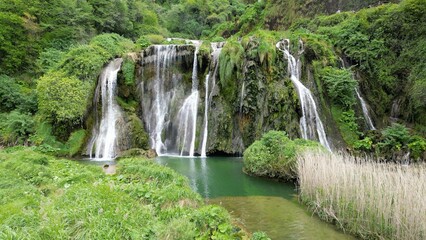 Italy, Umbria, Spectacular drone view of the Marmore Falls with water falling from above in a...