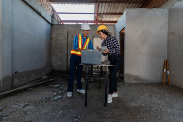 Asian industrial male and female engineers meeting, analyzing machinery blueprints, discussing...