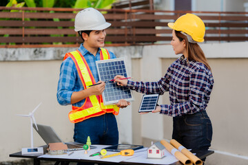 Asian industrial male and female engineers meeting, analyzing machinery blueprints, discussing...