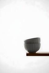 Minimalist gray ceramic bowls on wooden shelf for kitchen decor and food photography styling