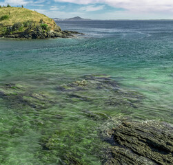 Part of Praia do Forte, with lots of rocks and crystal clear waters all along the beach, mountains...
