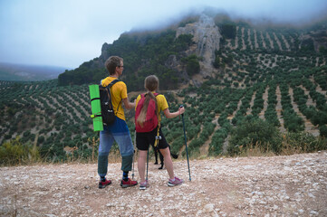 Couple Hiking in Scenic Mountain Landscape with Trekking Poles