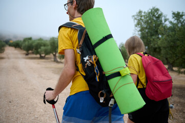 Young Hikers With Trekking Gear Exploring a Scenic Outdoor Trail