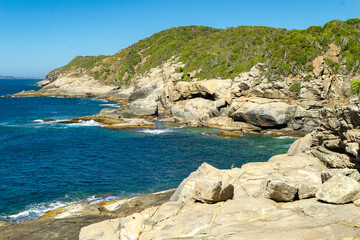 Top view of the back of Praia das Conchas. With large rocks and mountains in the background. Near the city of Cabo Frio, Rio de Janeiro.