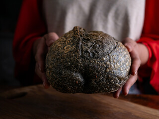 Woman hand hold fresh baked sourdough bread. Presenting Homemade ciabatta bread.