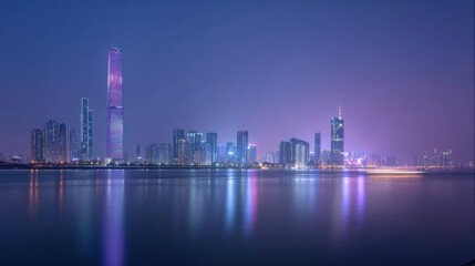 Fototapeta premium Modern city skyline at night reflecting on water with tall illuminated skyscrapers.