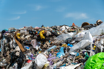 A large mound of plastic and rubbish is stacked high at a landfill, showcasing the growing issue of...