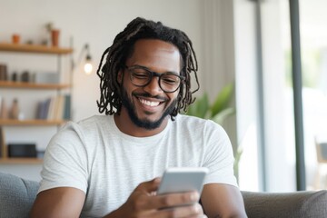 Happy man using smartphone and smiling at home