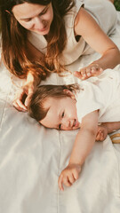 Mother with little daughter lying on blanket in park. Soft focus.  Close-Up