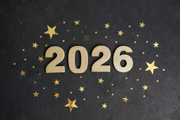 Golden numbers 2026 are centered on dark background surrounded by golden stars of varying sizes evoking festive and celebratory atmosphere. Ideal for New Year's greetings, calendars or designs