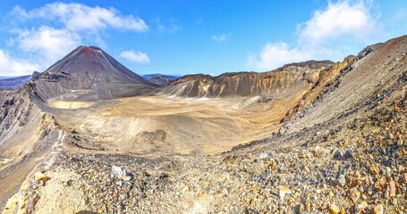 Dry volcanic crater under blue sky
